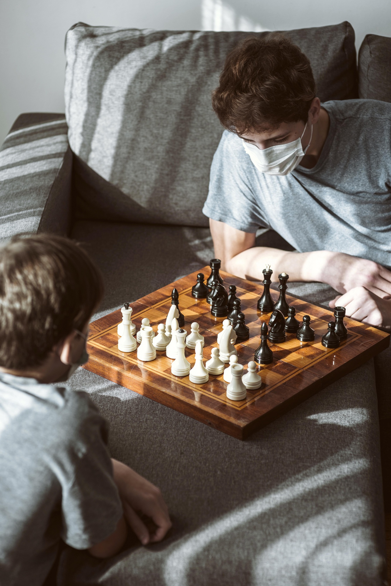 Dois meninos jogando xadrez juntos em uma mesa